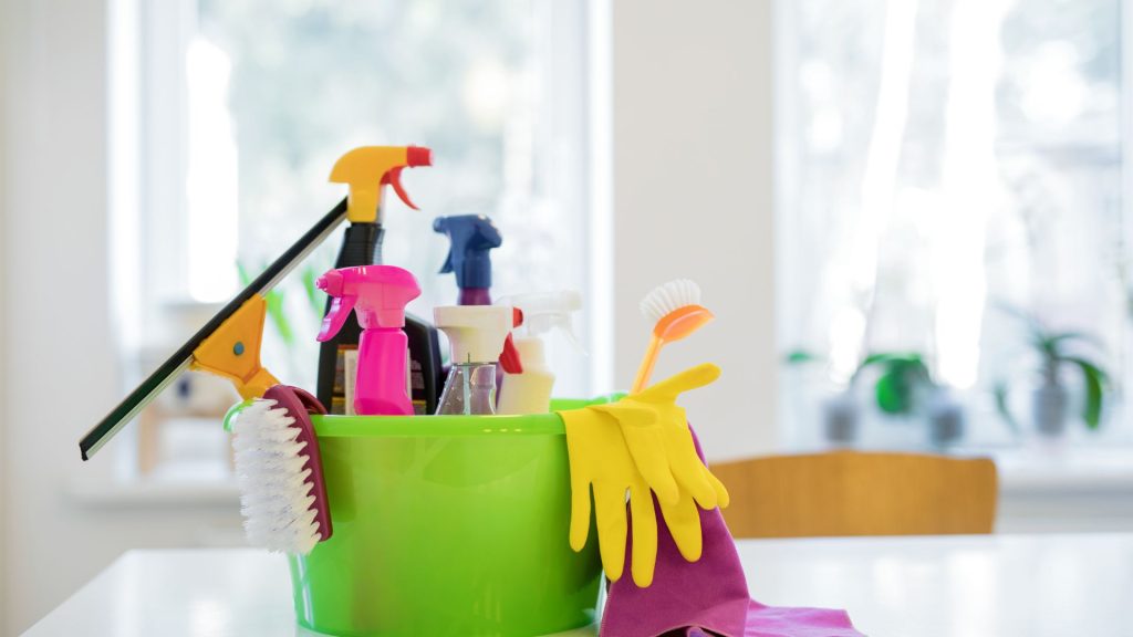 Cleaning supplies in a green bucket.