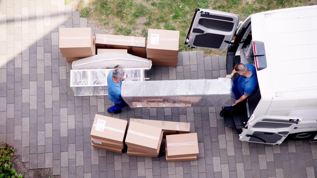 Workers loading furniture into a van